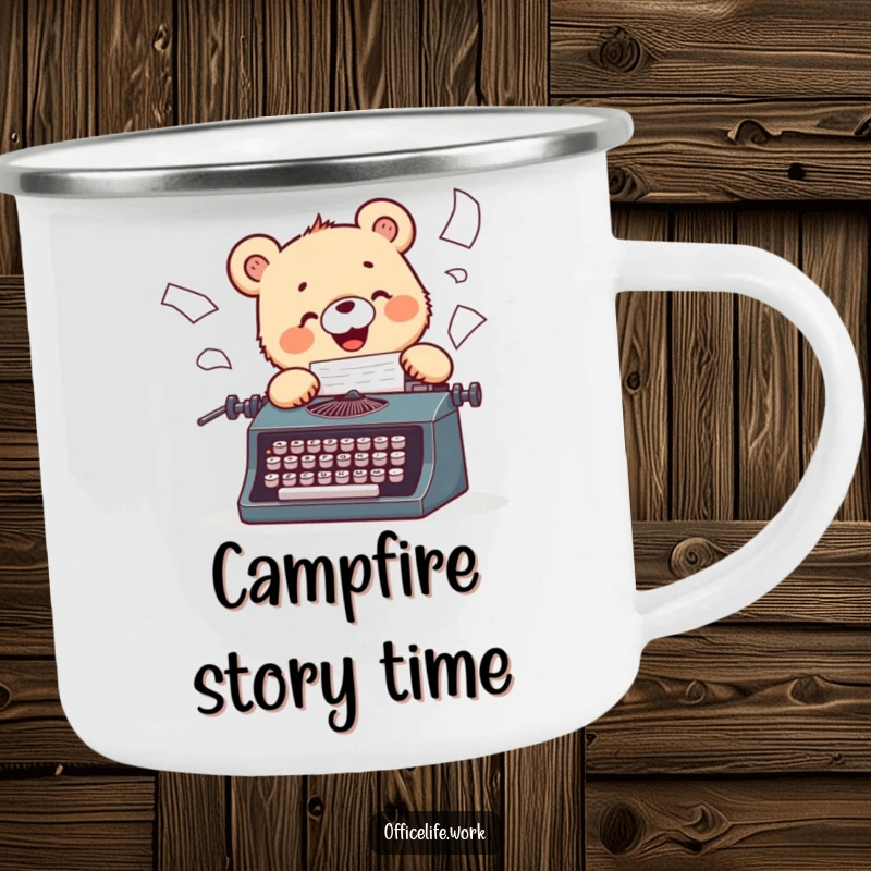 Funny camping mug showing a cheerful bear cub typing on a vintage typewriter, papers flying during an outdoor adventure.