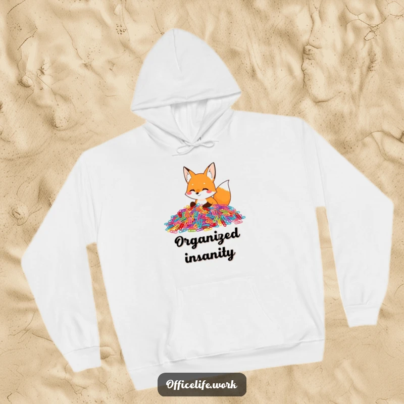 Funny hoodie illustrating a happy fox with intense focus, enthusiastically sorting a giant pile of colorful paper clips, a cozy delight.