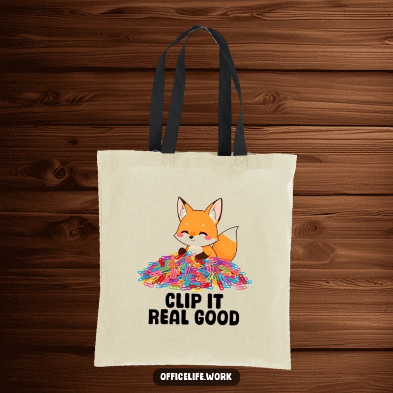 Funny tote bag featuring a happy fox diligently sorting a massive pile of colorful paper clips, a practical and amusing accessory.